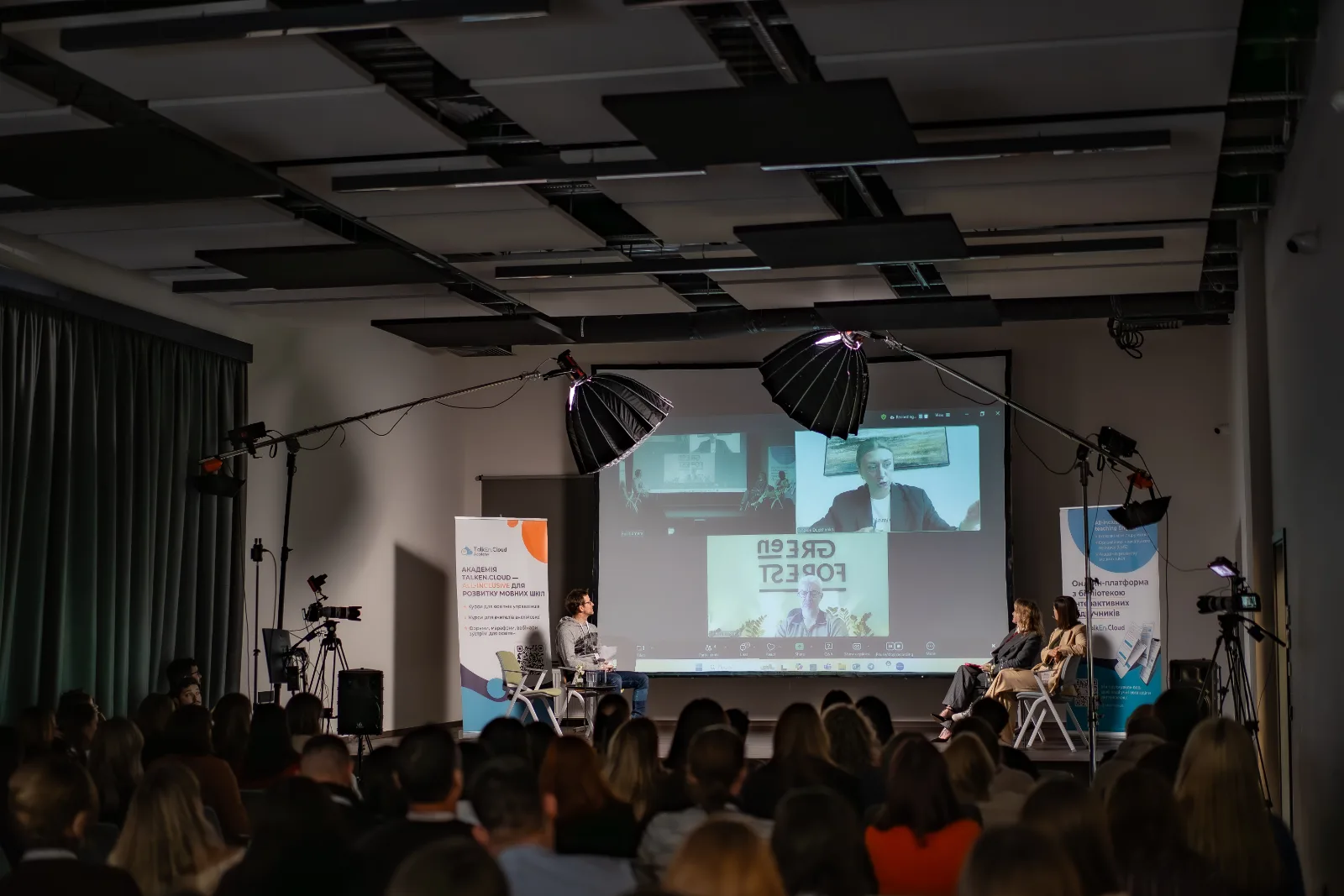 Speakers answering questions during a panel discussion at the forum