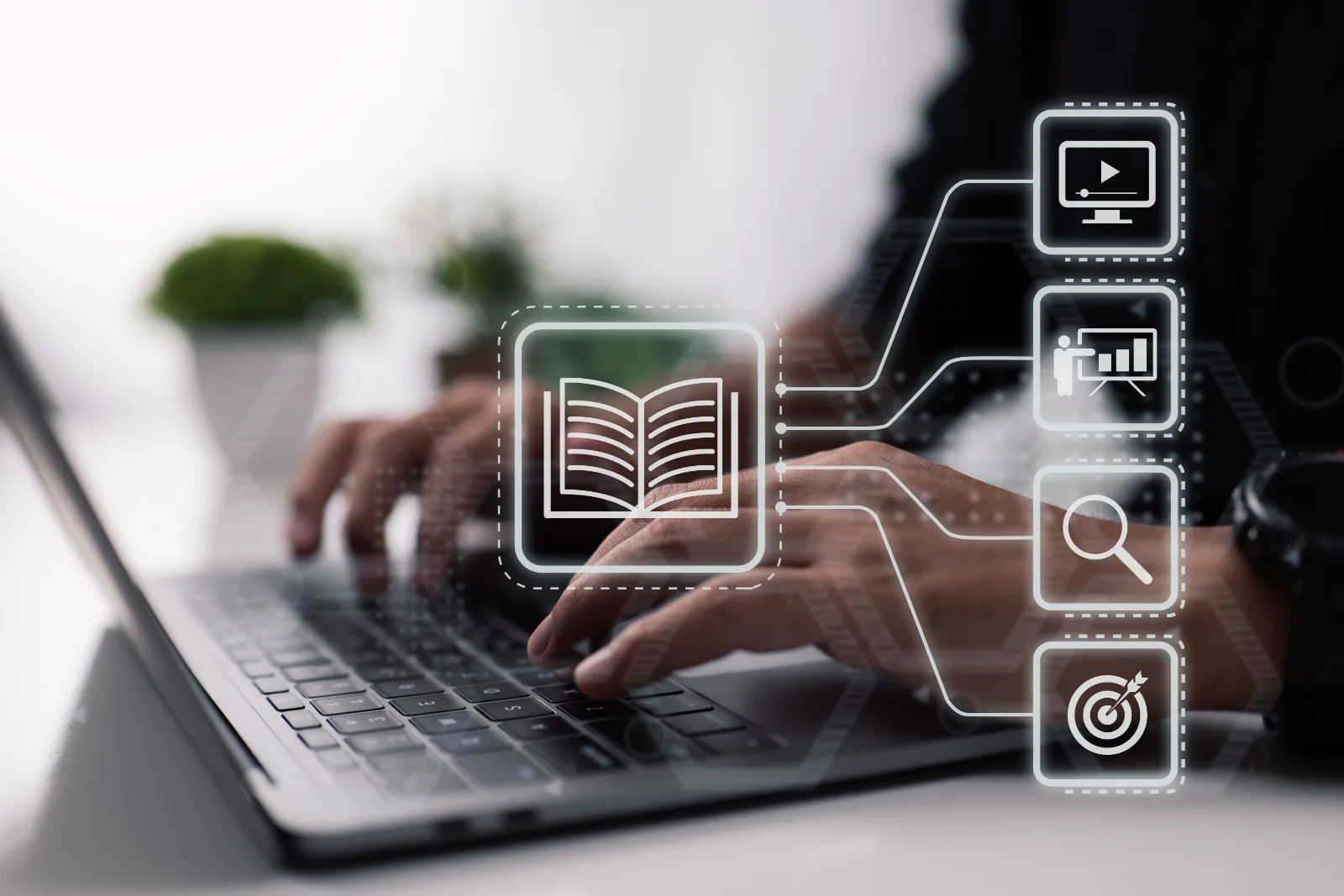 A teacher working with an online learning management system on a laptop